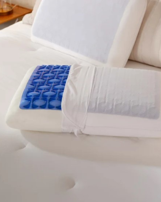 Sealy cooling gel memory foam pillow on bed, close-up of SealyChill gel layer and quilted cover, side view of medium support pillow in king size, removable and washable pillow cover unzipped, Sealy standard size memory foam pillow resting on mattress