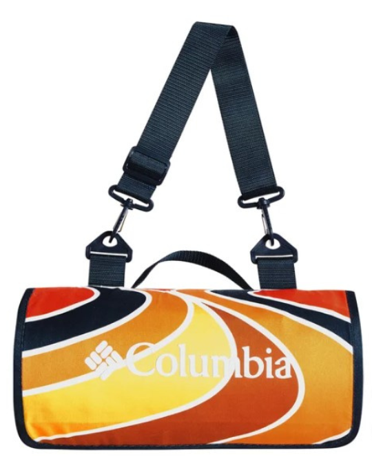 Columbia waterproof blanket rolled with strap, outdoor blanket laid on grass, reversible blanket close-up, folded Columbia picnic blanket, outdoor blanket with carry handle