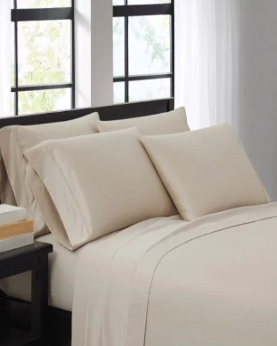 Luxurious Beige Pima cotton sheet set on bed, Kirkland Signature 680 thread count sheet set folded neatly, Fitted sheet with Grip-On™ corner fit technology close-up, Smooth wrinkle-resistant flat sheet detail, Full bedding set with pillowcases displayed on king-size bed